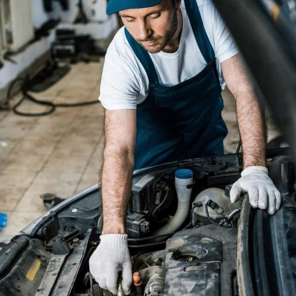 up-selective-focus-of-handsome-car-mechanic-fixing-au-2021-09-14-21-48-06-utc-min.jpg
